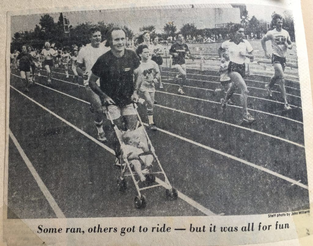 My dad pushing me in a stroller at a fun run (before running strollers were a thing).