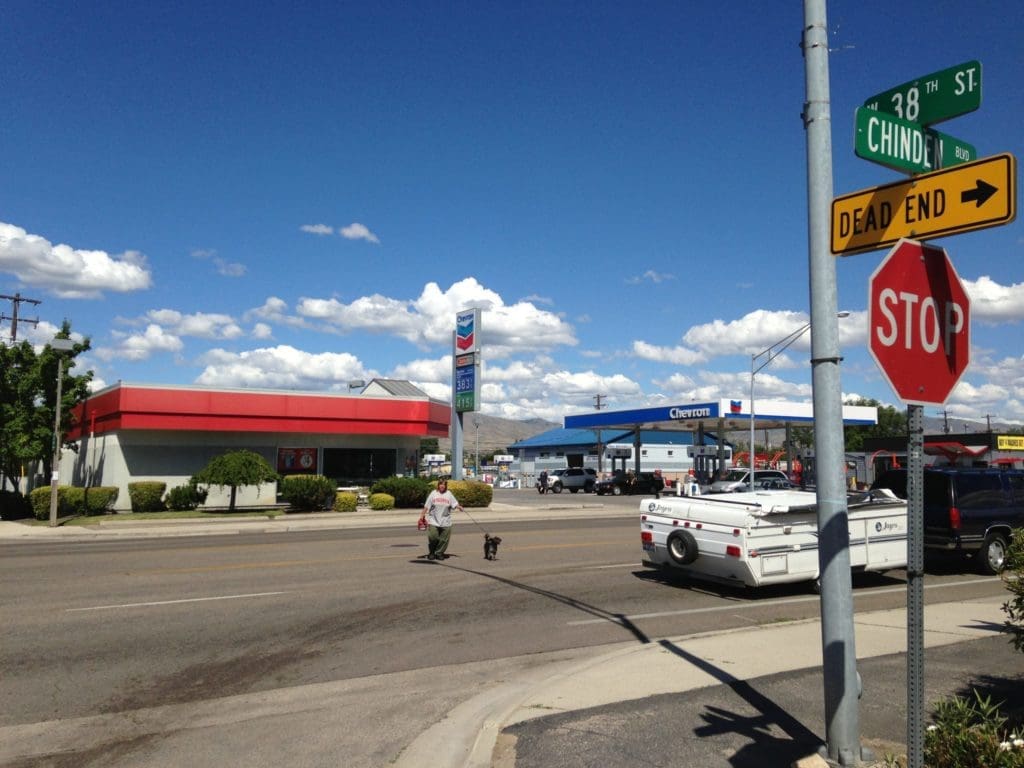 Pedestrian crossing Chinden Boulevard to get to a neighborhood market.