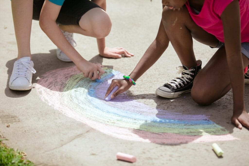 Kids drawing on sidewalk with chalk