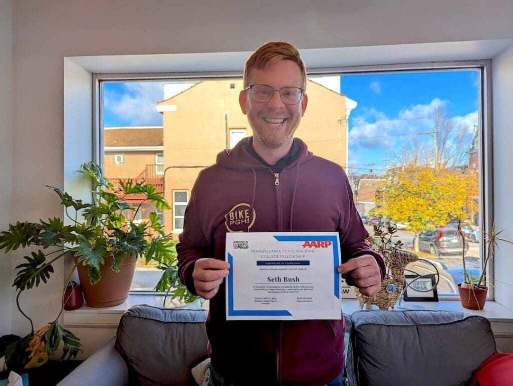 Seth holding his Walking College diploma.