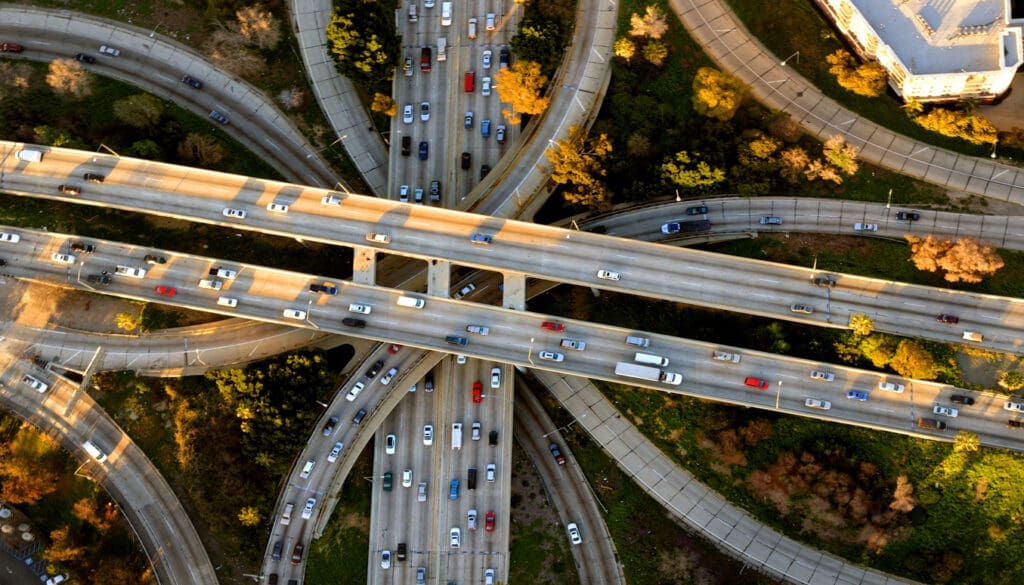 Helicopter Aerial View of the famous Los Angeles Four Level freeway interchange. The latest round of Reconnecting Communities and Neighborhoods Grant Program awards announced yesterday underscores the need for a transformational infrastructure bill that puts communities before highways.