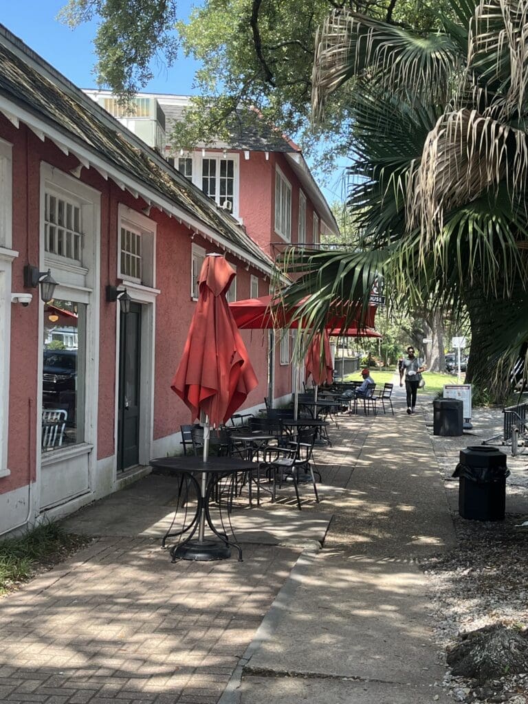 New Orleans neighborhood restaurant. The seating takes up much of the walkway, and the sidewalk is broken up.