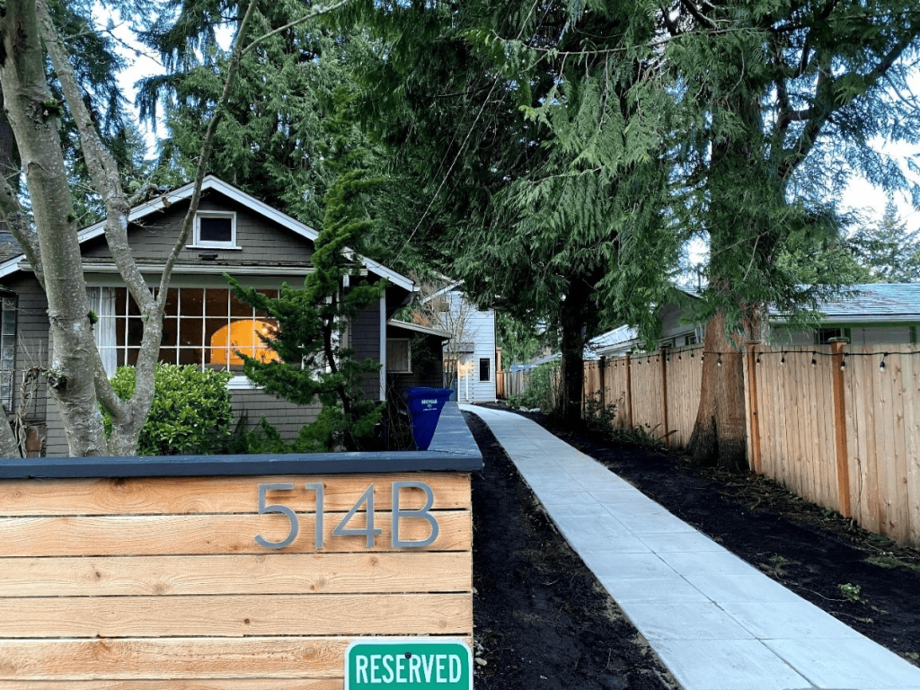 A cottage sits behind a home in seattle