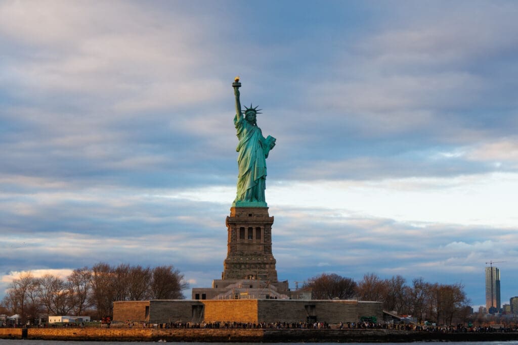 The statue of liberty in the center, with a blue sky backdrop.